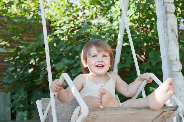 Laughing child on swing