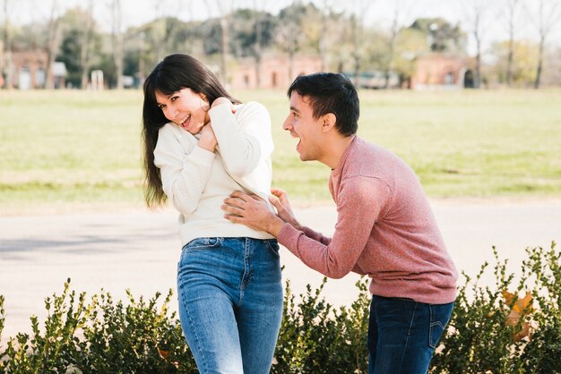 Laughing couple having fun in park