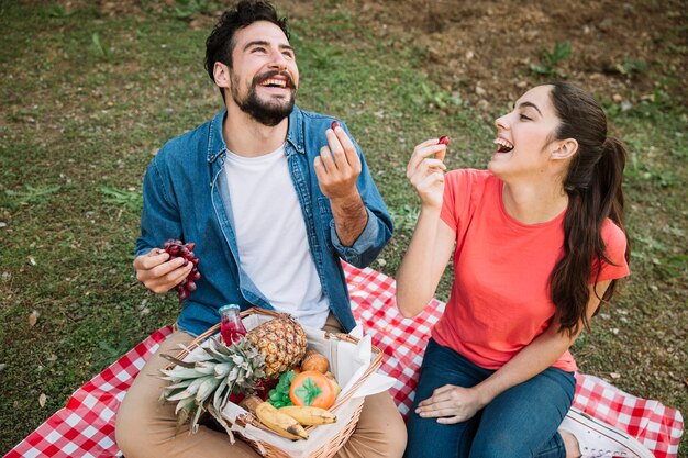 Laughing couple having a picnic