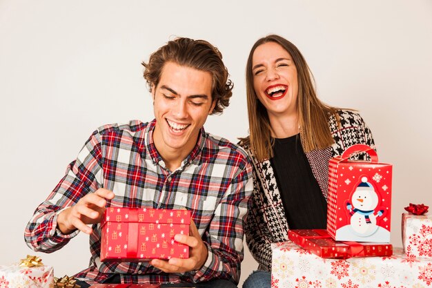 Laughing couple with various presents