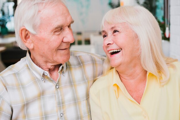 Laughing delighted senior couple
