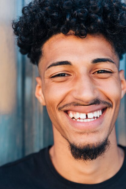 Laughing ethnic male with curly hair 