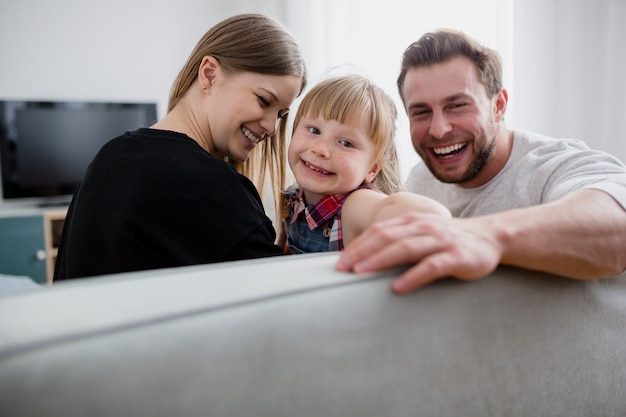 laughing family on couch