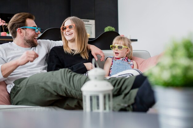 Laughing family watching film