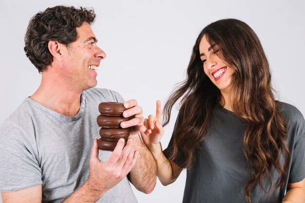 Laughing father and daughter with donuts