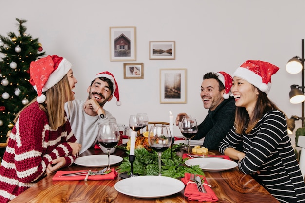 Laughing friends at christmas dinner