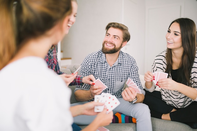 Laughing friends enjoying cards