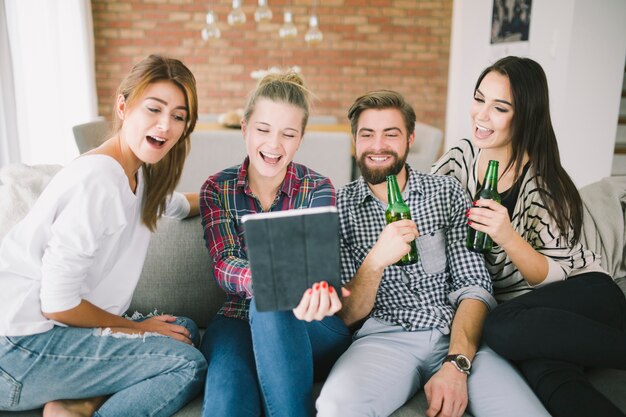 Laughing friends posing for selfie having party