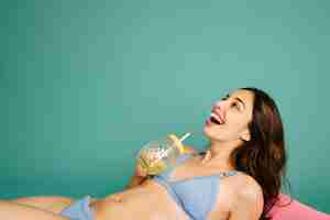 Free photo laughing girl lying on tropical mattress