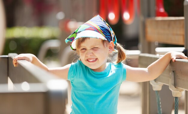 laughing  girl at playground area in sunny  day