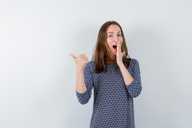 Laughing girl showing back with her left finger on white background