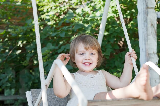 Laughing girl on swing