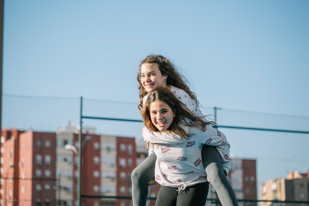 Laughing girls playing on rooftop