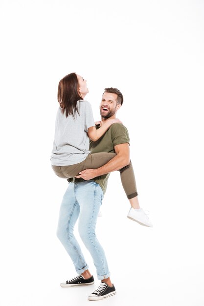 Free photo laughing man holding on hands woman