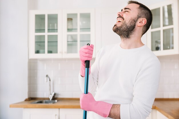 Laughing man with mop