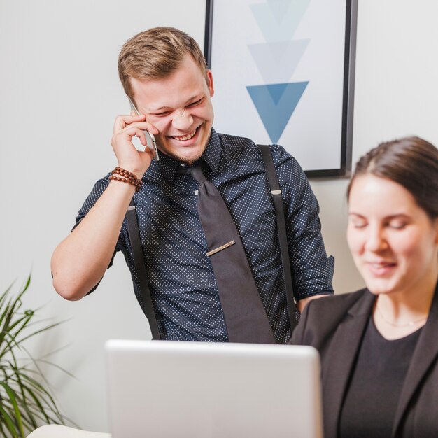 Laughing man and woman in office