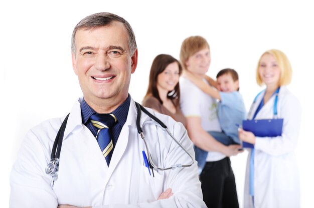 Laughing mature male doctor and the young happy family with little son