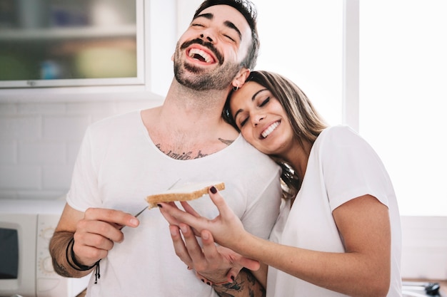 Free photo laughing people making breakfast together