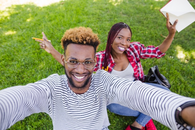 Laughing people posing on lawn