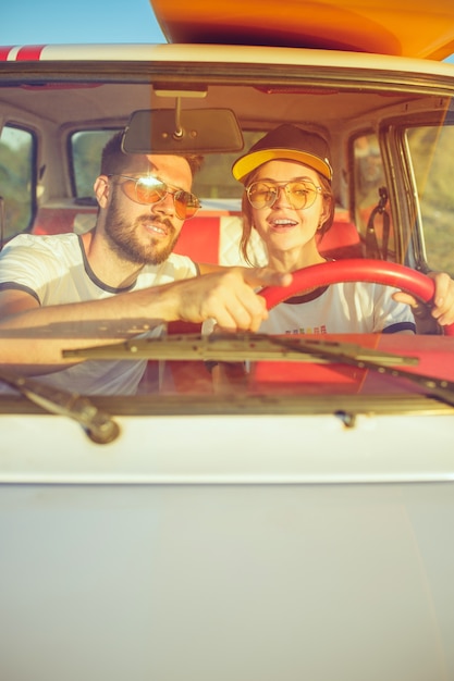 Free photo laughing romantic couple sitting in car while out on road trip