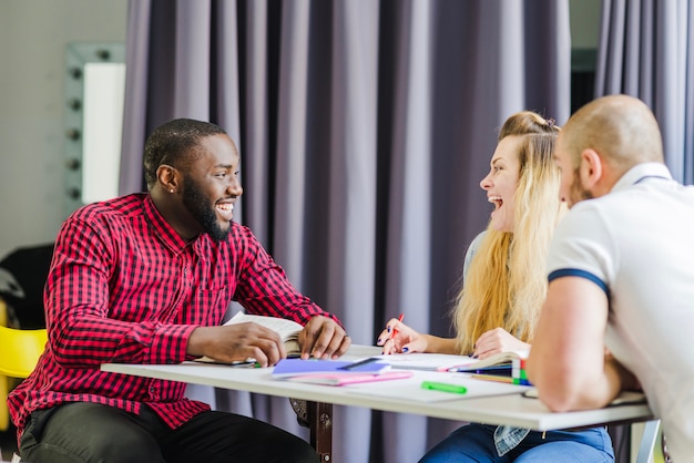 Free photo laughing students at table