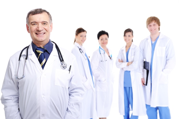 Laughing successful mature male doctor with his colleagues
