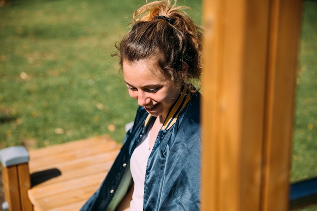 Laughing teen student resting at sportsground