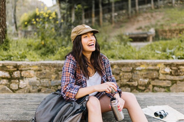 Laughing traveller with thermos