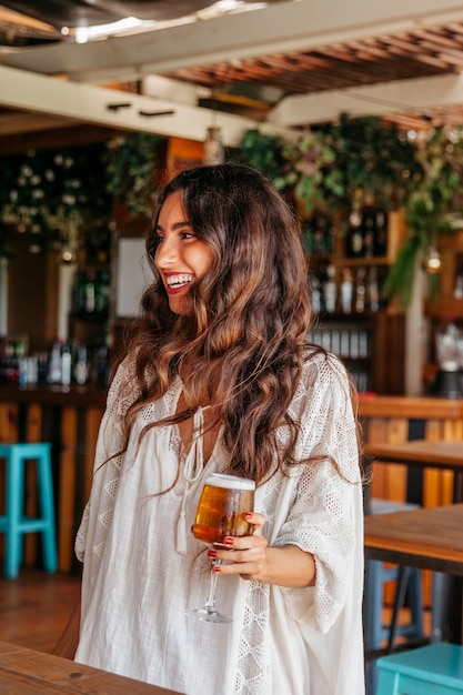 Laughing woman holding beer