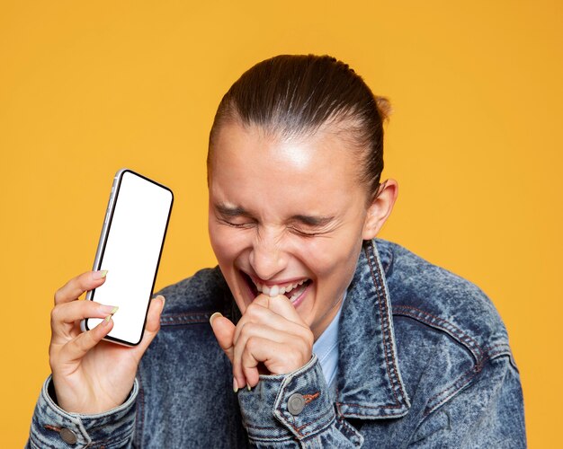 Laughing woman holding smartphone