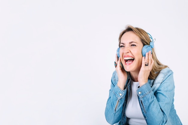 Laughing woman listening to music