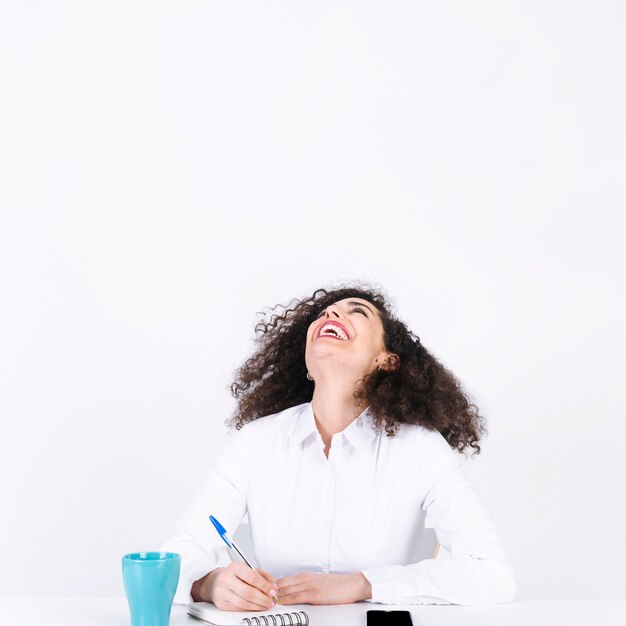 Laughing woman making notes