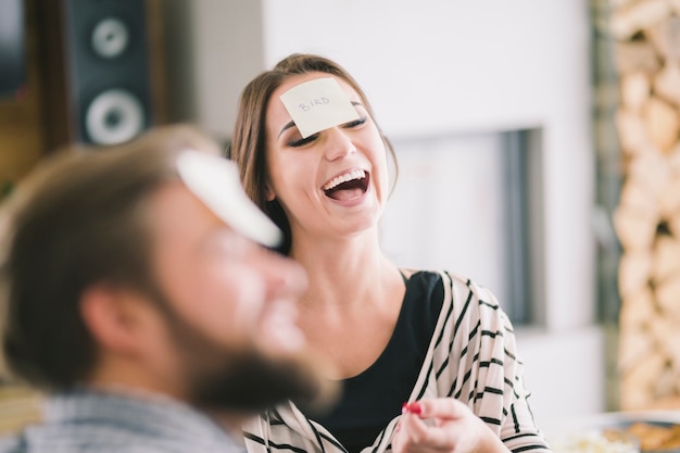 Free photo laughing woman playing game with friends