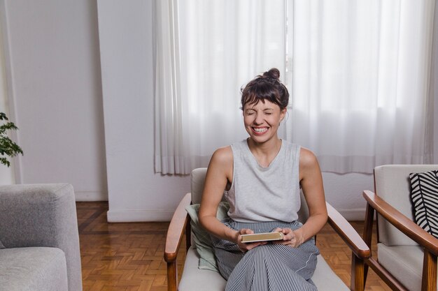 Laughing woman sitting on chair