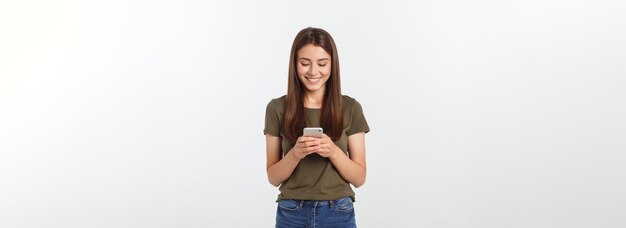 Laughing woman talking and texting on the phone isolated on a white background