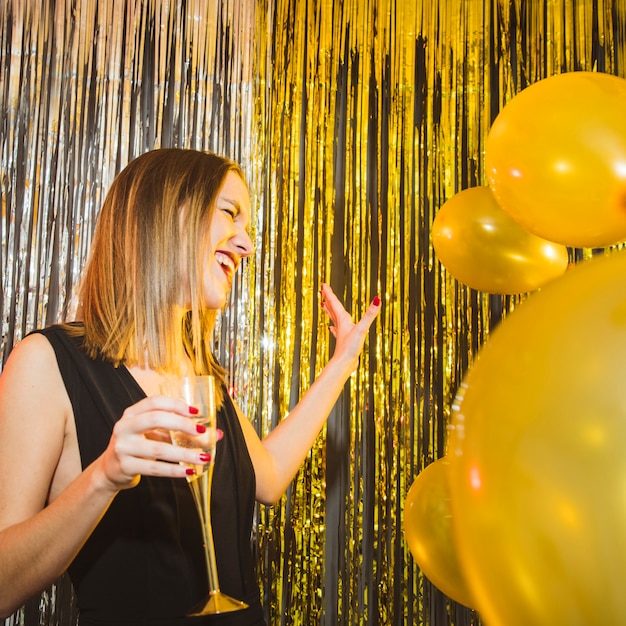 Laughing woman with balloons at new year celebrations