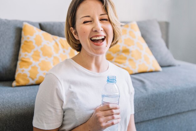 Laughing woman with water bottle