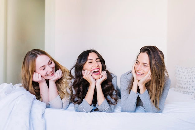 Free photo laughing women on bed