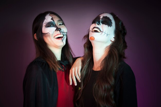 Laughing women dressed as witches