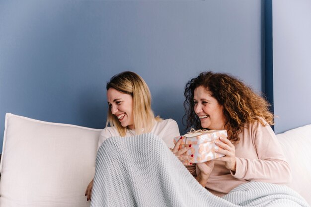 Laughing women exchanging presents