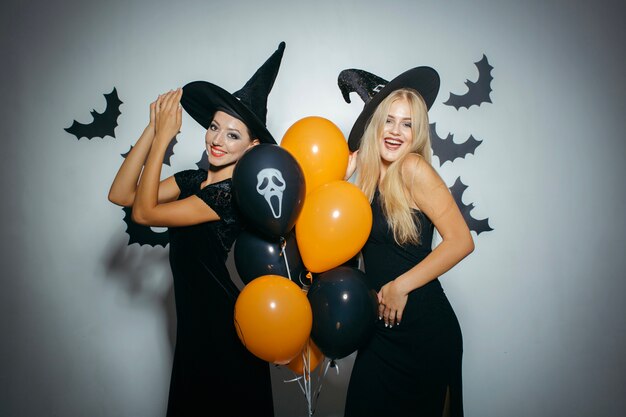 Laughing women in Halloween costumes