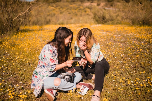 Free photo laughing women looking at picture