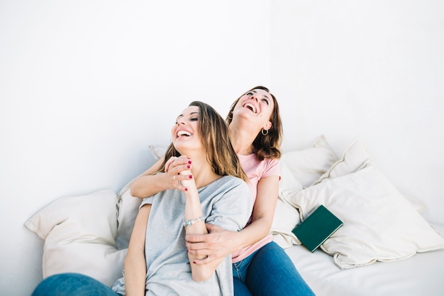 Laughing women on sofa