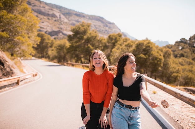 Laughing women with lollipops