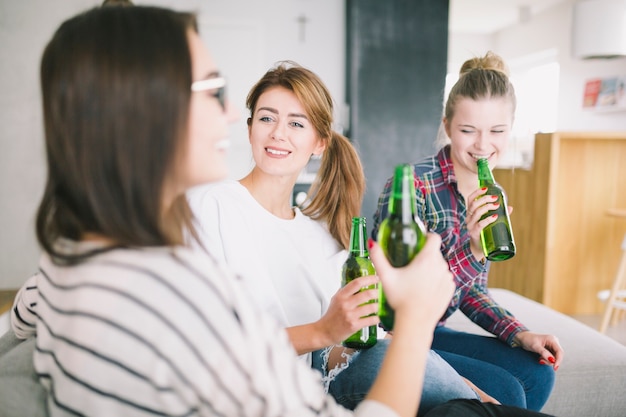 Laughing young women drinking beers