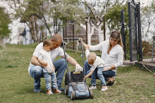 Lawn mower man working on the backyard with sons