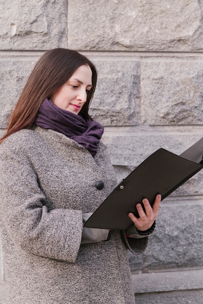 Free photo lawyer outdoors looking at folder