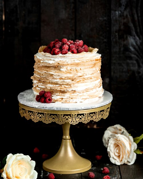 Free photo layered crepe cake topped with raspberries