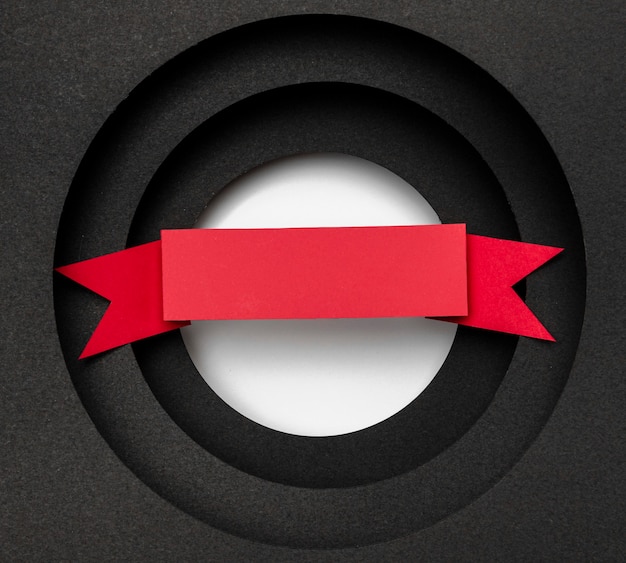 Layers of circular black background and red ribbon