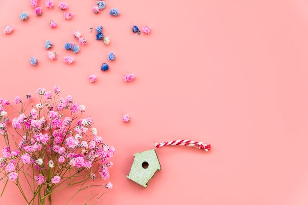 Layout with flowers and wooden box on pink background